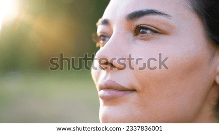 A closeup portrait of a young woman looking away from the camera	
 Royalty-Free Stock Photo #2337836001