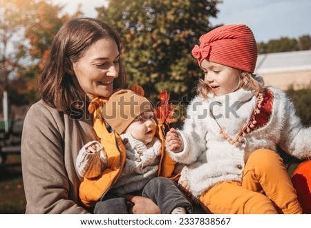 Cheerful family on the farm. Parenting and childhood. Motherhood. Autumn Thanksgiving Day. Outdoor games. Harvesting at farm. Vacation home. Yard decor Royalty-Free Stock Photo #2337838567