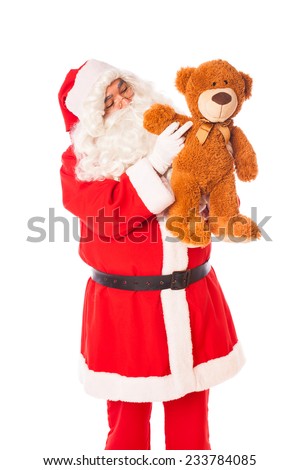 santa claus playing and waving with a teddy bear on white 