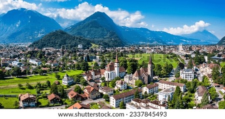 Aerial view over the city of Interlaken in Switzerland. Beautiful view of Interlaken town, Eiger, Monch and Jungfrau mountains and of Lake Thun and Brienz. Interlaken, Bernese Oberland, Switzerland. Royalty-Free Stock Photo #2337845493