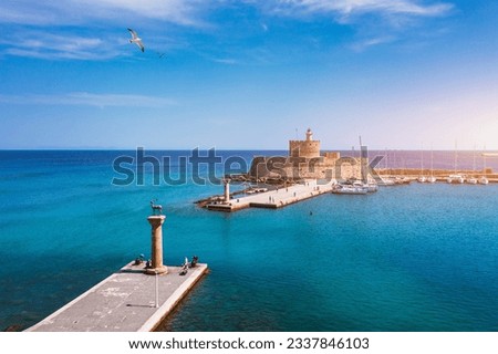 Mandraki port with deers statue, where The Colossus was standing and fort of St. Nicholas. Rhodes, Greece. Hirschkuh statue in the place of the Colossus of Rhodes, Rhodes, Greece Royalty-Free Stock Photo #2337846103