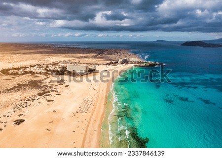 Aerial view of beach in Corralejo Park, Fuerteventura, Canary Islands. Corralejo Beach (Grandes Playas de Corralejo) on Fuerteventura, Canary Islands, Spain. Beautiful turquoise water and white sand. Royalty-Free Stock Photo #2337846139