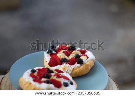 Two small homemade pavlova cakes, served in the garden. Selective focus.
