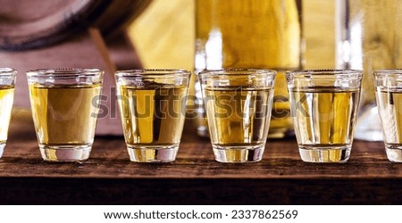 Hand holding glass of alcoholic drinks, cachaça, drips, rum and cognac. Selection of strong and hard alcoholic drinks, glasses. Vodka, cognac, whiskey, grappa, liqueur, vermouth, tincture, rum. Royalty-Free Stock Photo #2337862569
