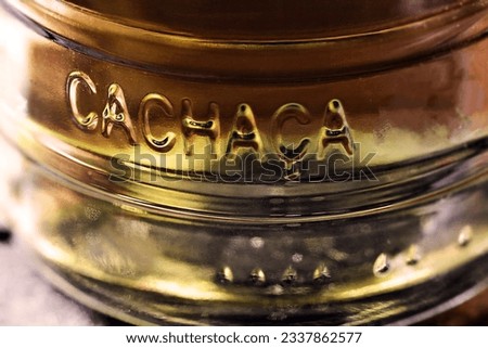 Detail of a bottle of cachaça, a typical Brazilian drink. Brazilian product for export, distilled drink known as aguardente or pinga. Day of cachaça. Royalty-Free Stock Photo #2337862577