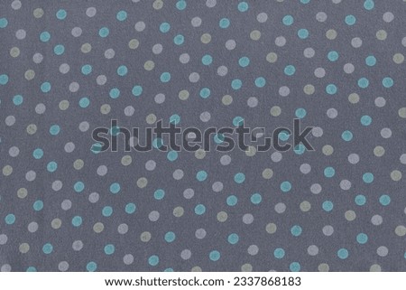 The texture of natural gray cotton fabric with cheerful polka dots. A napkin for the house made of a simple soft natural fabric. Abstract fabric background.