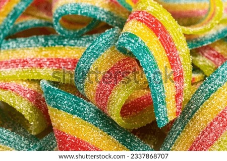 Rainbow sour jelly candies strips in sugar sprinkle.