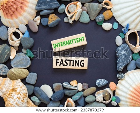 Intermittent fasting symbol. Concept words Intermittent fasting on beautiful wooden block. Beautiful black table black background. Healthy lifestyle intermittent fasting concept. Copy space.