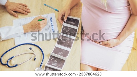 A doctor in a clinic examines a pregnant woman. Selective focus. People.