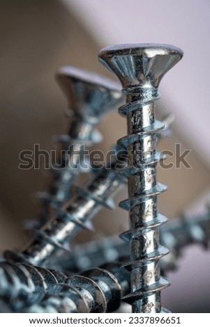 Pile of shiny galvanized screws with in bokeh. Closeup of a metalware. Royalty-Free Stock Photo #2337896651