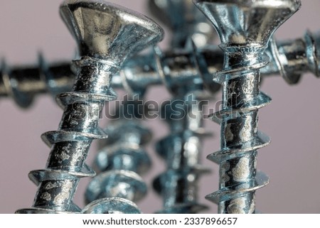 Pile of shiny galvanized screws with in bokeh. Closeup of a metalware. Royalty-Free Stock Photo #2337896657