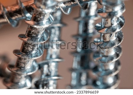 Pile of shiny galvanized screws with in bokeh. Closeup of a metalware. Royalty-Free Stock Photo #2337896659