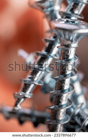 Pile of shiny galvanized screws with in bokeh. Closeup of a metalware. Royalty-Free Stock Photo #2337896677