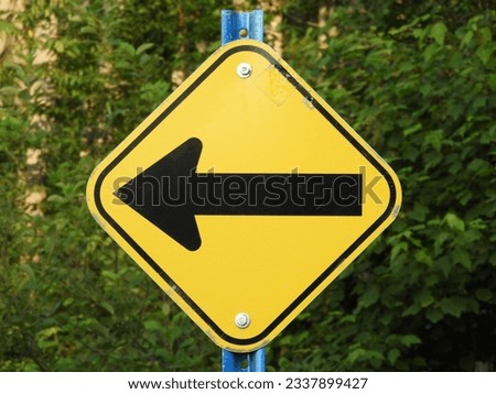 Turn to the left yellow arrow road sign Royalty-Free Stock Photo #2337899427