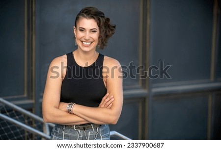 Confident and cheerful pose of a charismatic, energetic, charming artist, unique style and hair style Royalty-Free Stock Photo #2337900687
