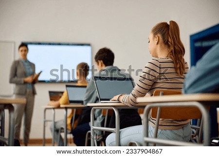 Female high school student learning coding on laptop during computer programing class in the classroom. Royalty-Free Stock Photo #2337904867