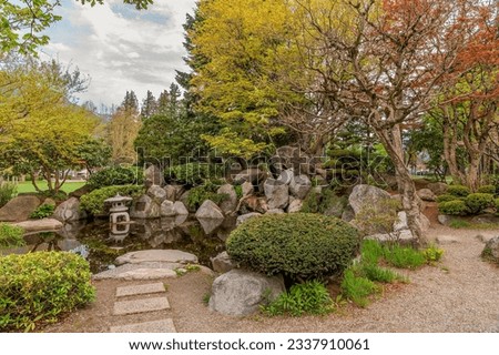 Steps leading towards a pond and a Japanese style garden. 