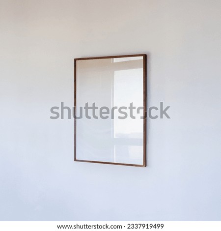 Wooden frame portrait on white wall. poster mockup a4, 50x70, 30x40. Scandinavian style wooden empty frame mockup for poster, social media, website, business, shop, advertisement.