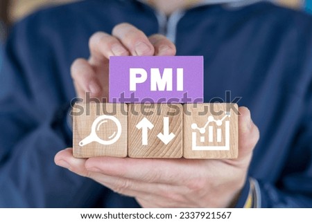 Man holding colorful blocks sees abbreviation: PMI. Concept of PMI - Purchasing Managers Indexes. Manufacturing and Service Sector Economic Outlook Index. PMI Project Management Institute. Royalty-Free Stock Photo #2337921567