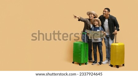 Excited happy young black family father mother kid preteen son traveling together isolated on beige background, carrying suitcases, wearing summer hats, holding map, pointing at copy space, banner