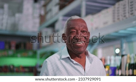 Portrait of a joyful Black Senior Brazilian man smiling at camera standing inside supermarket laughing Royalty-Free Stock Photo #2337929091