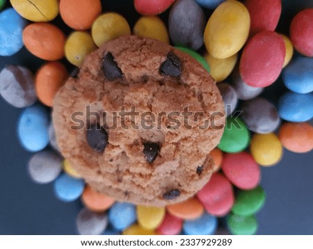 Colorful candy balls and cookies ornament on black background.