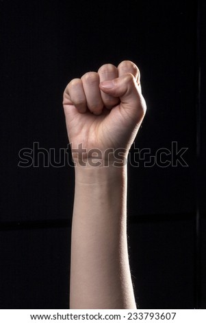 A human hand make fist and means ten in the china, shi, chinese hand language isolated black at the studio. 