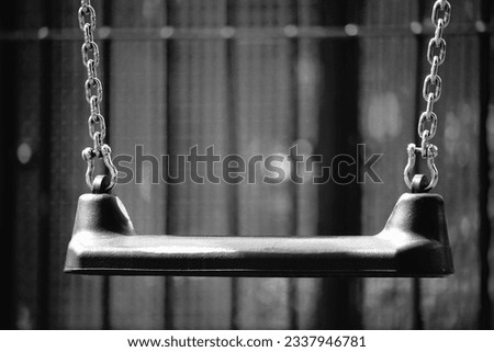 Black and white empty swing  Royalty-Free Stock Photo #2337946781