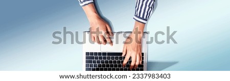 Person using a laptop computer from above