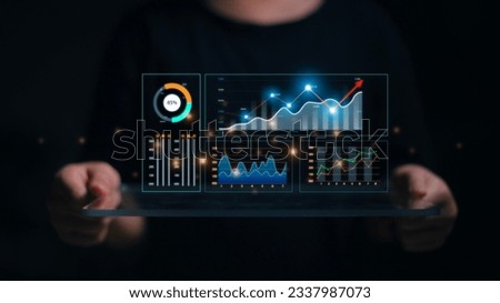 Data analyst working on business analytics dashboard with charts, metrics and KPI to analyze performance and create insight reports and strategic decisions for operations management on virtual screen. Royalty-Free Stock Photo #2337987073