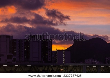 Kowloon famous landmark Lion rock mountain is located at the right hand-side and public housing in the left hand-side, with the background of sunset. logo is removed