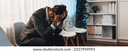 Nervous and panic job applicant with stressful emotion on job interview while he sitting and waiting for his turn. Sad businessman holding his head with hands after making mistake. Trailblazing Royalty-Free Stock Photo #2337994993