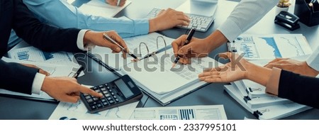 Auditor and accountant team working in office, analyze financial data and accounting record with calculator. Accounting company provide finance and taxation planning for profitable cash flow. Insight Royalty-Free Stock Photo #2337995101