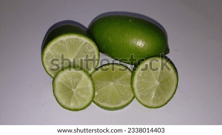 A lime cut in half and sliced in half.