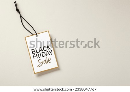 Black friday sale tag with gold border on beige background with copy space