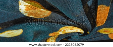 Silk fabric, blue with a print of yellow autumn leaves. Texture, background pattern