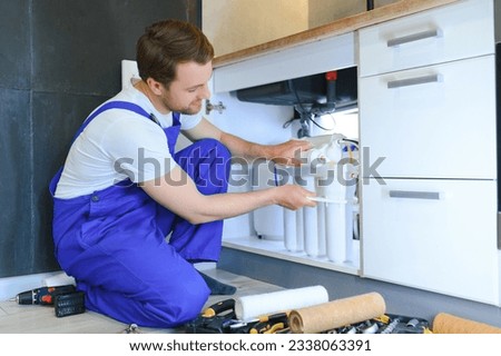 plumber change the water filter. Royalty-Free Stock Photo #2338063391
