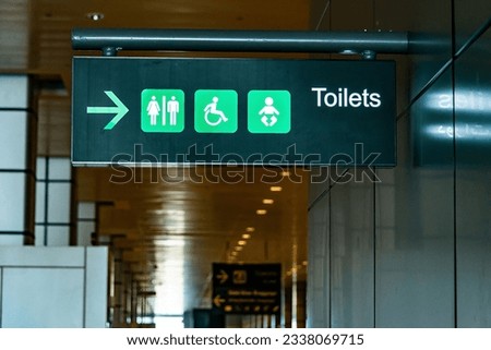 Toilet sign on the ceiling of entrance to bathroom in Airport Toilet sign concept. Icons set. Male and female restroom