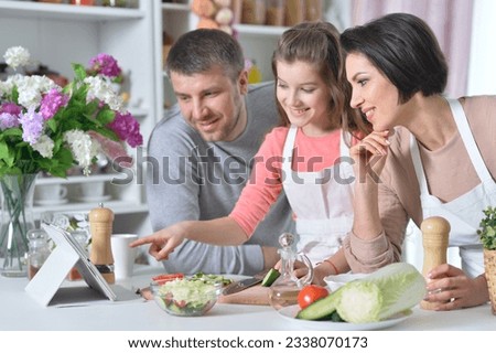 young family cooking together. High quality photo
