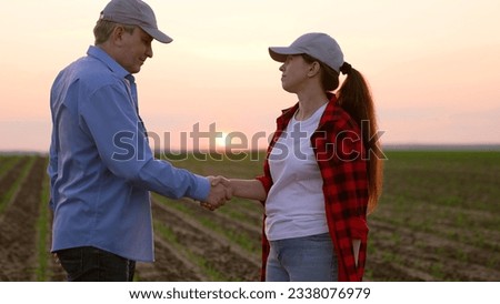 two farmers work field handshakemachinery road insurance wealth digital horizon slow pc cereal view garden labor sky worker inspect, corporate sunset, work tablet agriculture, hand sun farming farm Royalty-Free Stock Photo #2338076979