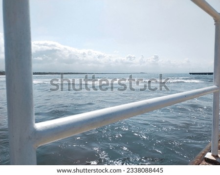 Pictures of a beautiful iron guardrail leading to the sea; nature background