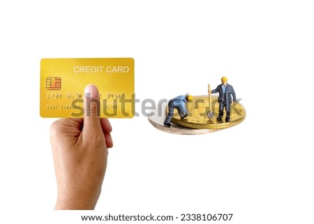 Miniature worker with demo credit card and coin on white background.