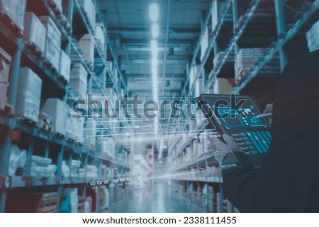 Manager using smart tablet monitor process Analyzes, check and control product in stock warehouse, modern software, futuristic concept smart warehouse management system in Factory industry in  Royalty-Free Stock Photo #2338111455