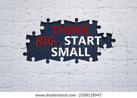 Think big start small symbol. Concept words Think big start small on white puzzle. Beautiful black background. Business and Think big start small concept. Copy space. Conceptual word