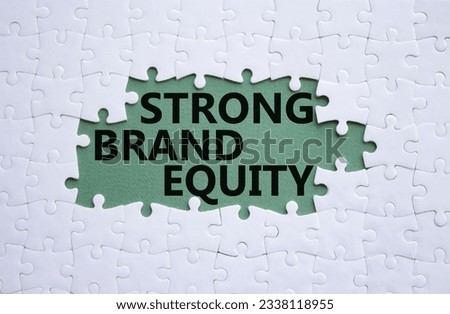 Strong Brand Equity symbol. Concept words Strong Brand Equity on white puzzle. Beautiful grey green background. Business and Strong Brand Equity concept. Copy space