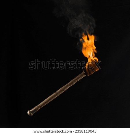 burning wooden torch isolated on black background Royalty-Free Stock Photo #2338119045