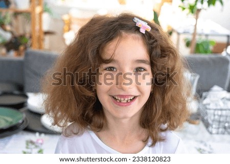 Toothless happy smile of a girl with a fallen lower milk tooth close-up. Changing teeth to molars in childhood Royalty-Free Stock Photo #2338120823