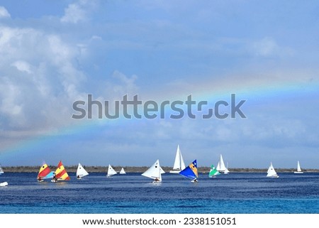 Sailing regatta competition sunfish boats sport colorful rainbow sky Caribbean coast Royalty-Free Stock Photo #2338151051