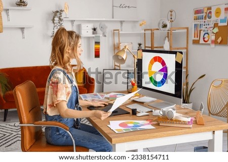 Female graphic designer working at table in office