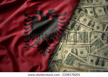 big colorful waving national flag of albania on a american dollar money background. finance concept